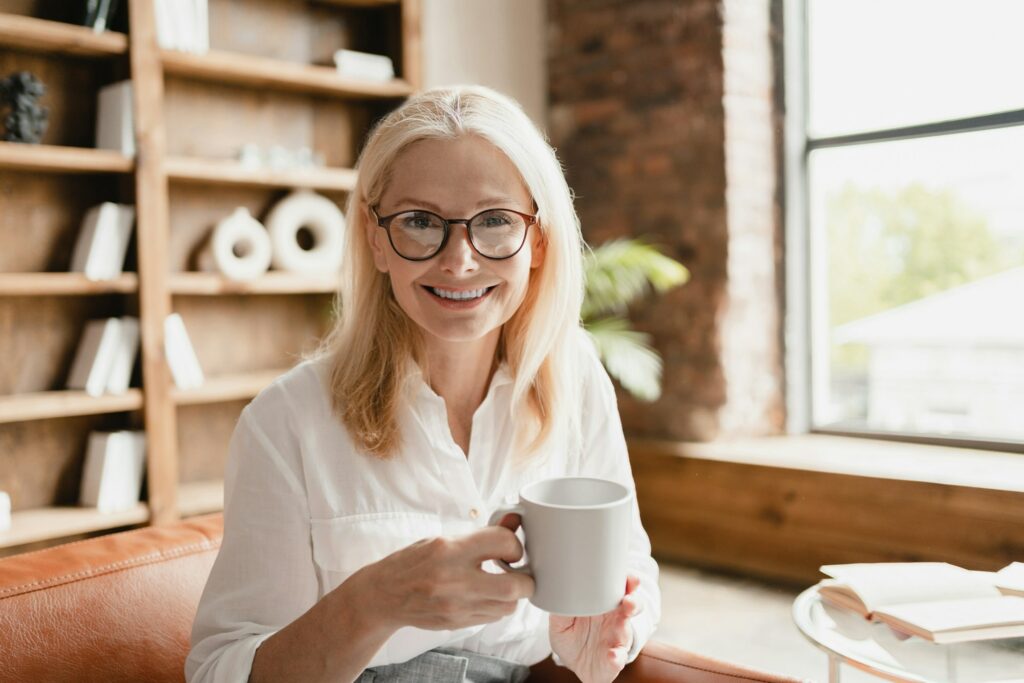 Psychologist listening to clients patients while drinking coffee in office library, working remotely