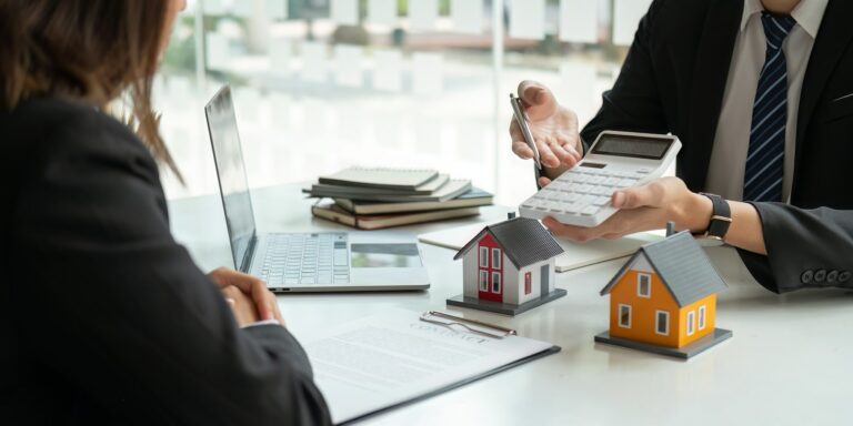 Real estate agents talk to client and offer good interest rates and calculate clients on mortgage